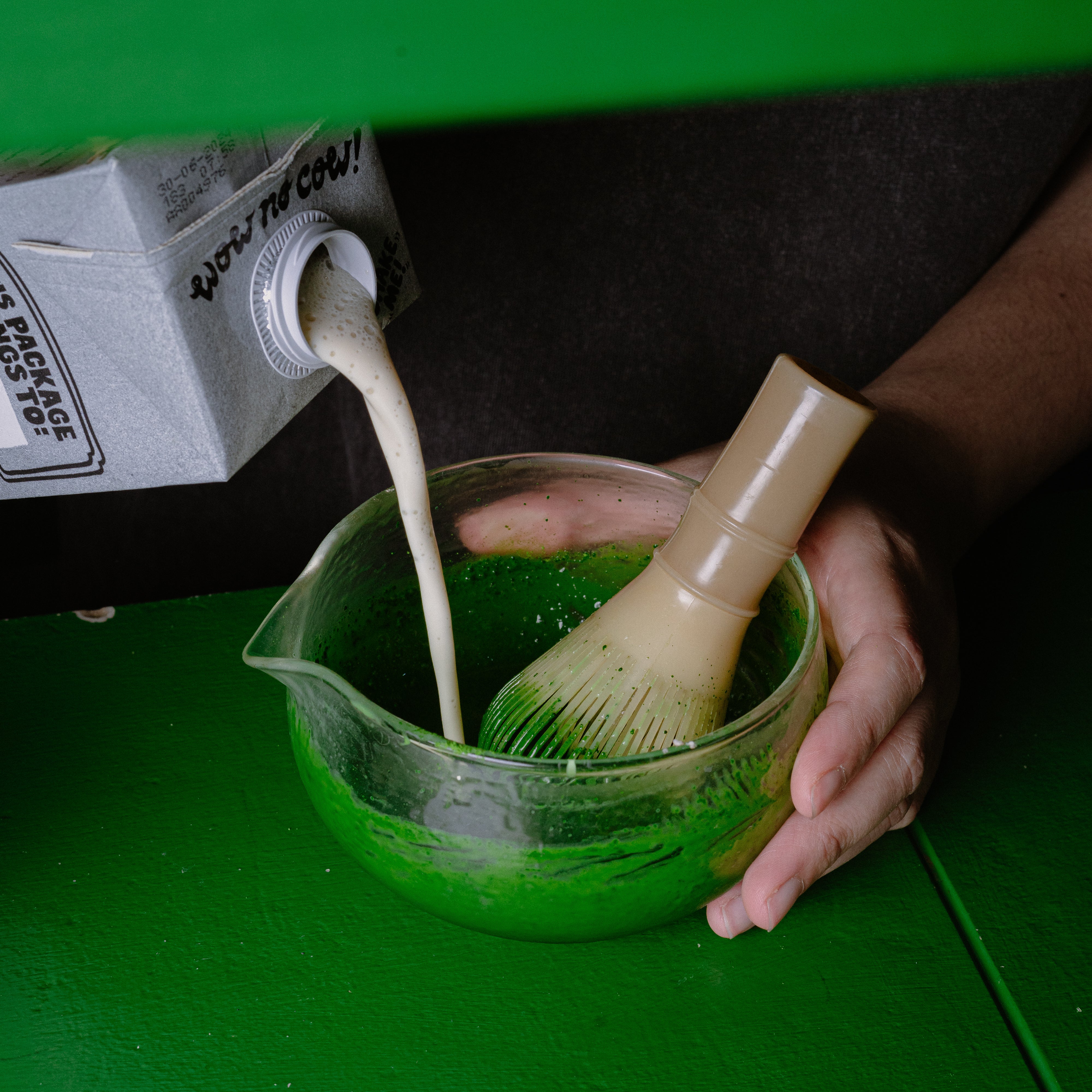 Pouring matcha with with bamboo whisk